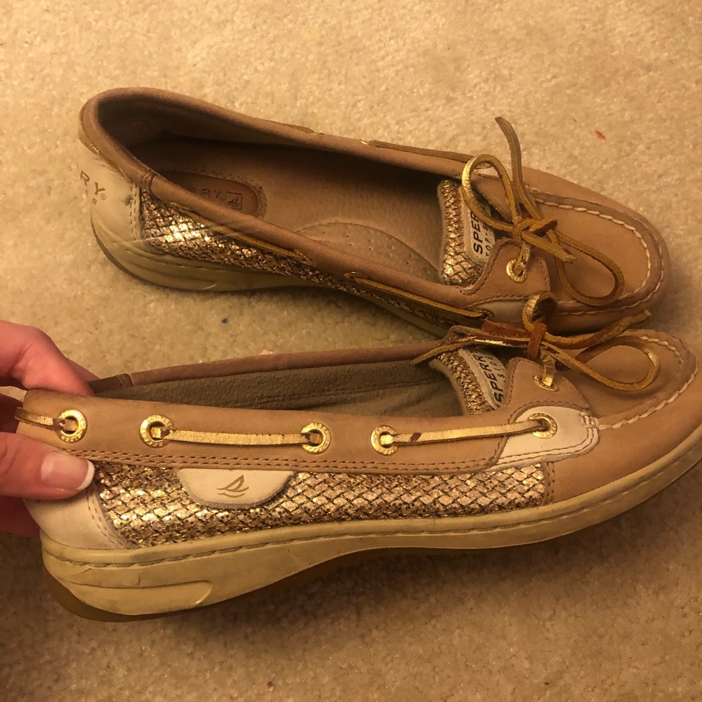 Woman’s Sperry top-sider shoes with gold shimmer